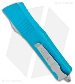 Microtech Combat Troodon OTF Knife D/E Dagger Turquoise (3.8" Satin Serr) -Knife Shop Microtech Combat Troodon OTF DE Dagger Turquoise Satin Serr 142 5TQ BHQ 98094 jr side 1